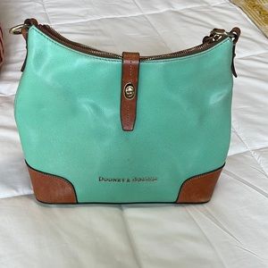 Used Teal dooney and Bourke purse. Cute lining on the inside